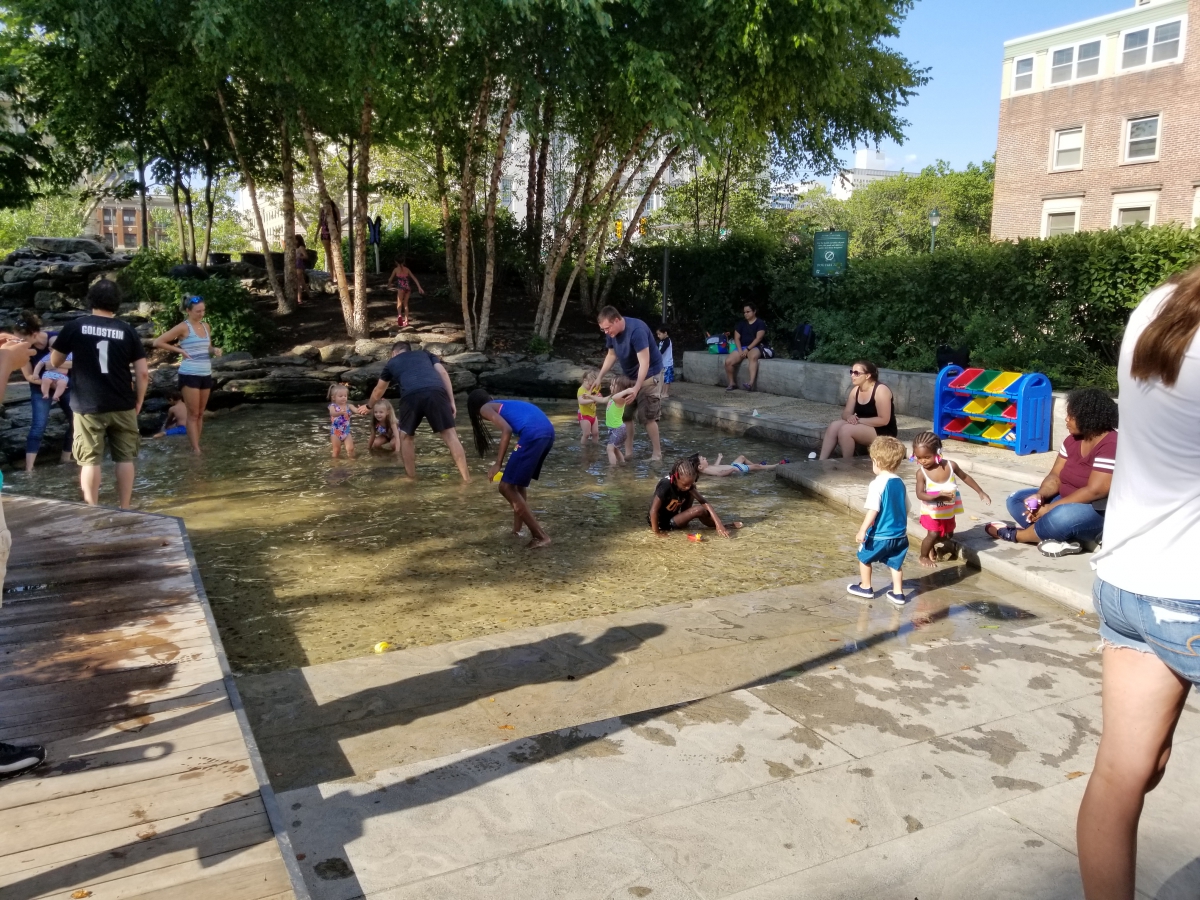 Children enjoying the pond at Sister Cities Park Children enjoying the pond at Sister Cities Park