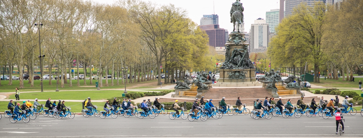 Indego Bicyclists Circle Eakins Oval at Indego Launch Event - Photo Courtesy Indego Indego Bicyclists ride around Eakins Oval at Indego Launch Event - Photo Courtesy Indego
